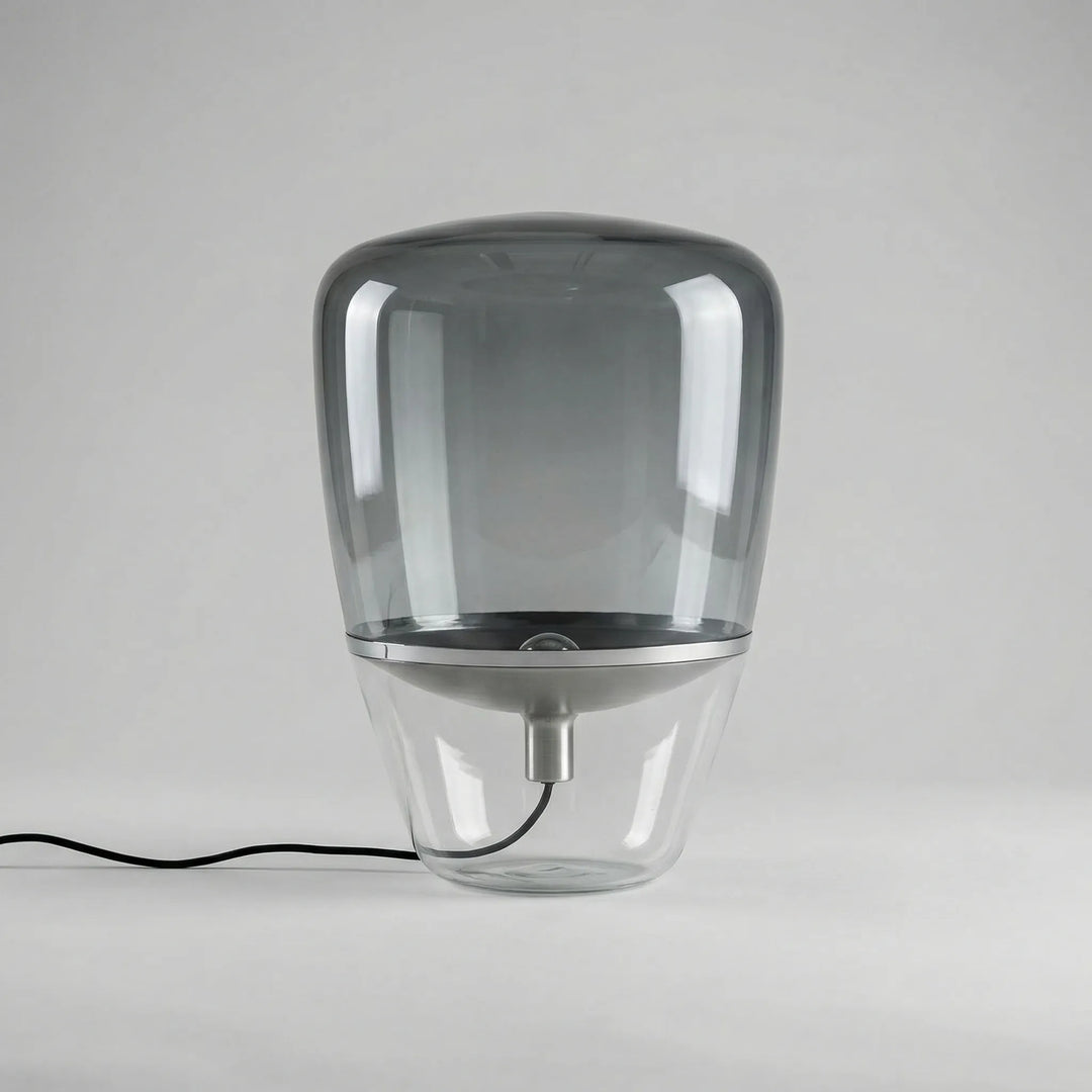 Nordella minimalist glass table lamp providing ambient LED lighting for a modern living room.