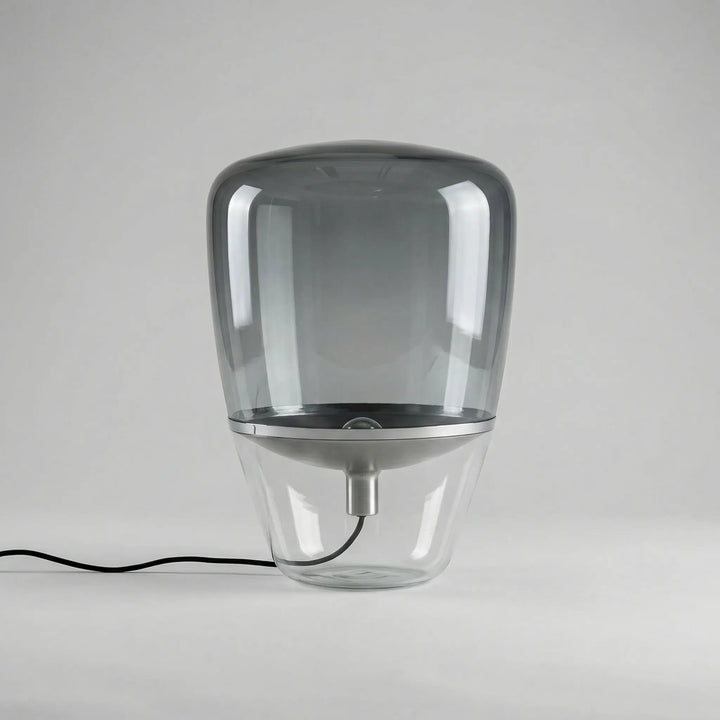 Nordella minimalist glass table lamp providing ambient LED lighting for a modern living room.