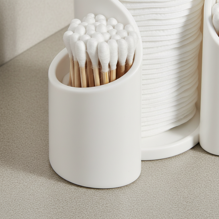 Clear plastic cotton pad holder and swab dispenser, essential minimalist bathroom storage.