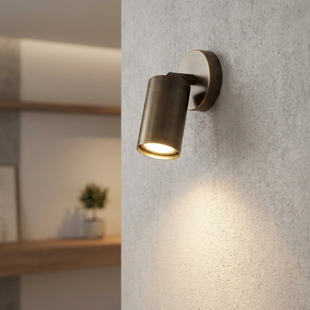 Minimalist cylindrical LED wall sconce in black, providing modern ambient lighting for home decor.