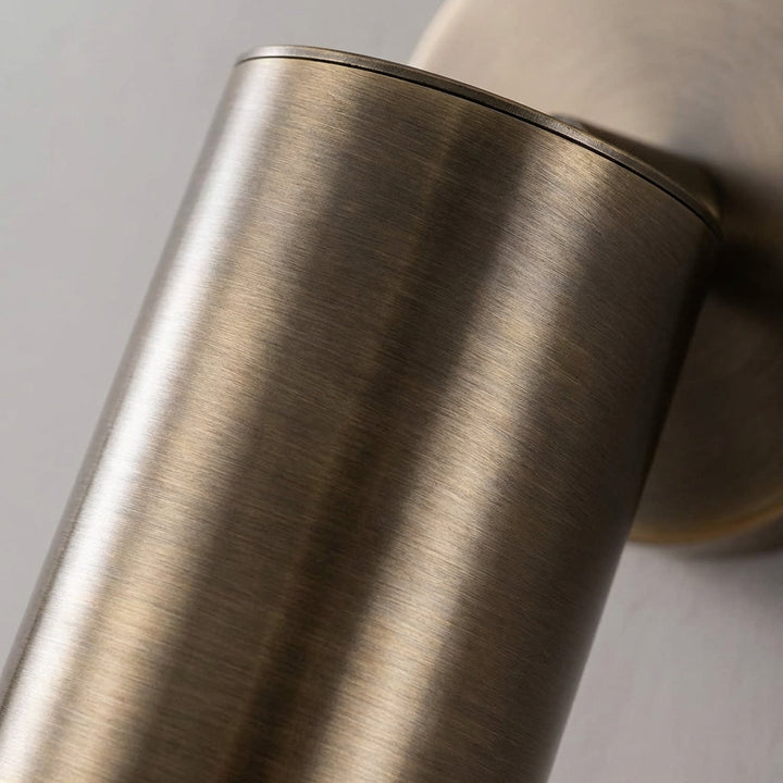 Modern cylindrical LED wall sconce offering elegant ambient light, enhancing any minimalist living space.