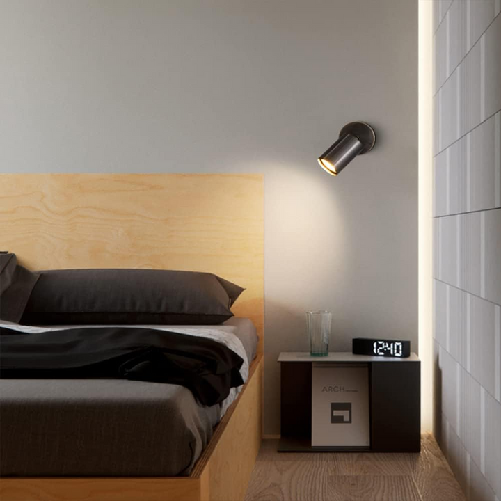 Black cylindrical LED wall sconce, a stylish indoor lighting fixture for contemporary home decor.