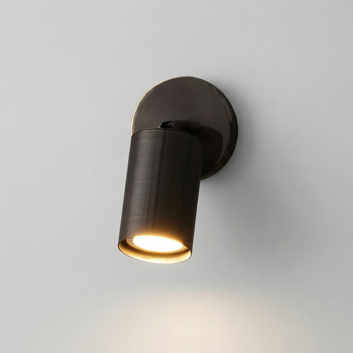 Minimalist NoirLume LED wall sconce, a cylindrical design emitting soft, modern ambient light.