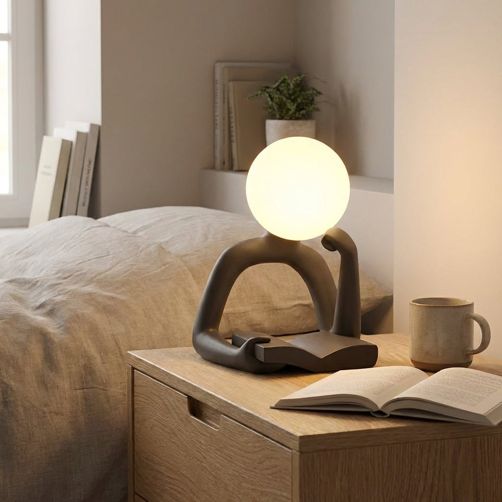 Minimalist sculptural LED desk lamp, modern resin design, ambient lighting for home decor.