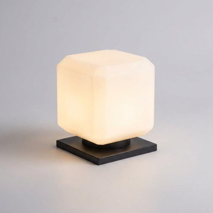 Compact Lumiqube Solar Cube Outdoor Lamp charging in sunlight, weatherproof garden light.