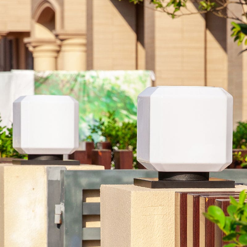 Close-up of a Lumiqube cube outdoor light, showcasing its sleek design and solar panel.