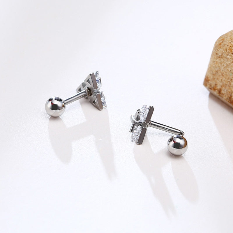 Unisex geometric triangle stud earrings in sterling silver, simple and modern for minimalist everyday style.