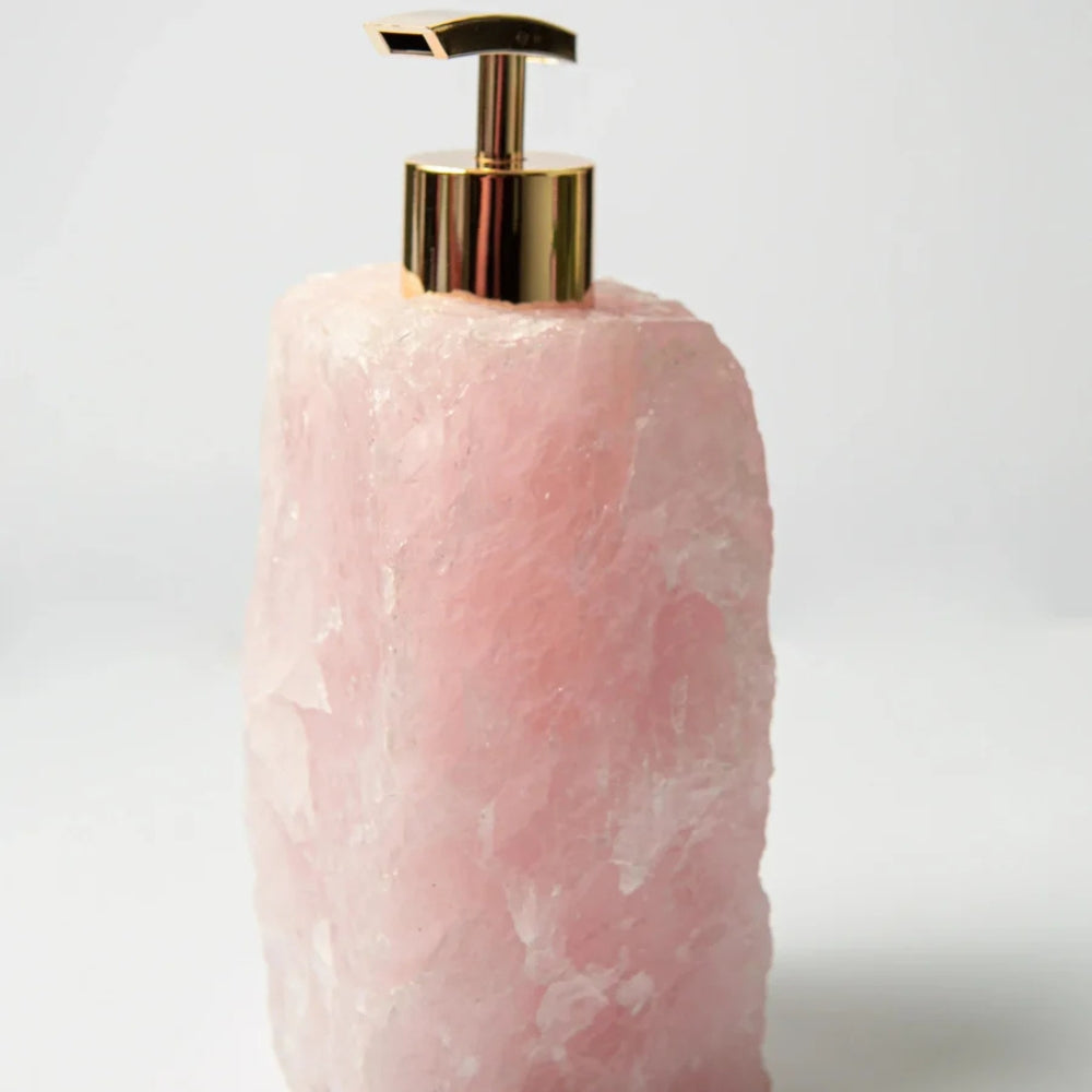 Modern bathroom accessory: sleek soap dispenser in a neutral stone finish.