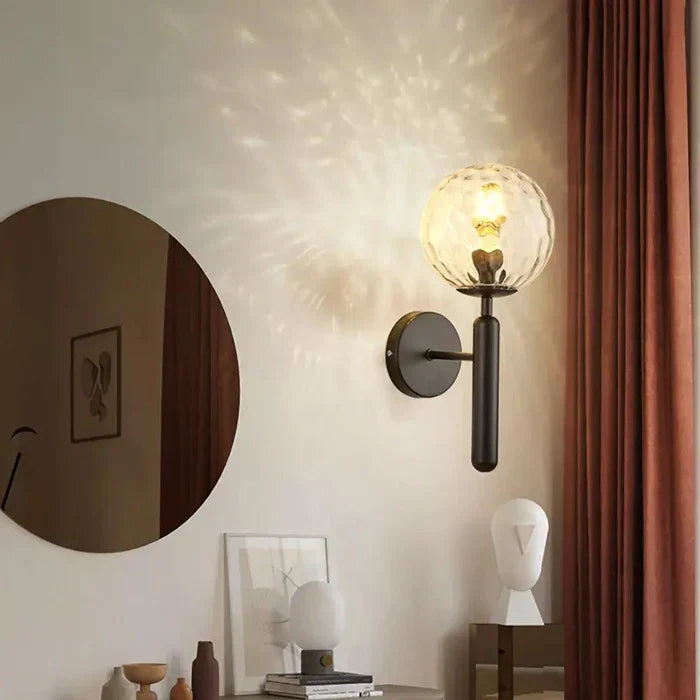 Modern LED wall sconce by Veloriq, black finish, rippled glass, adds minimalist touch to decor.