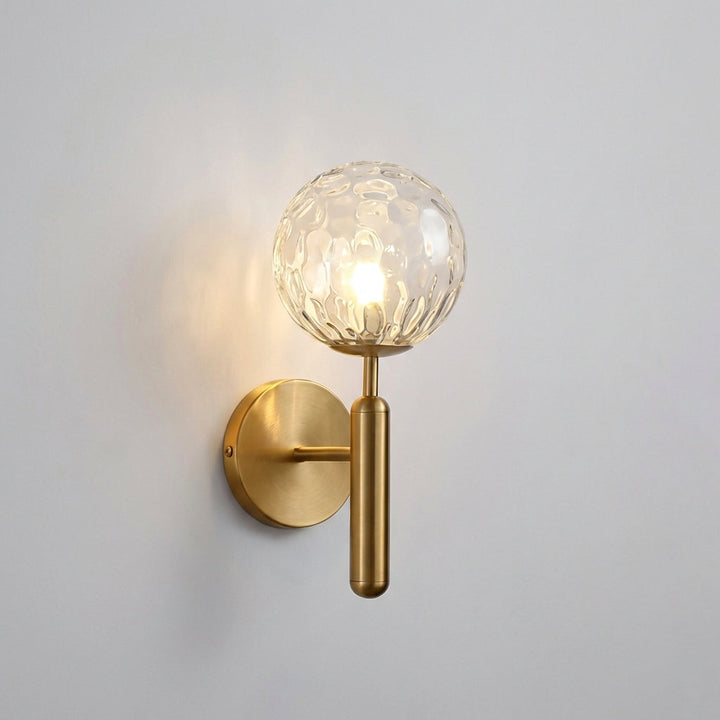 Sleek black Veloriq LED wall sconce, rippled glass, delivers warm ambient home lighting.