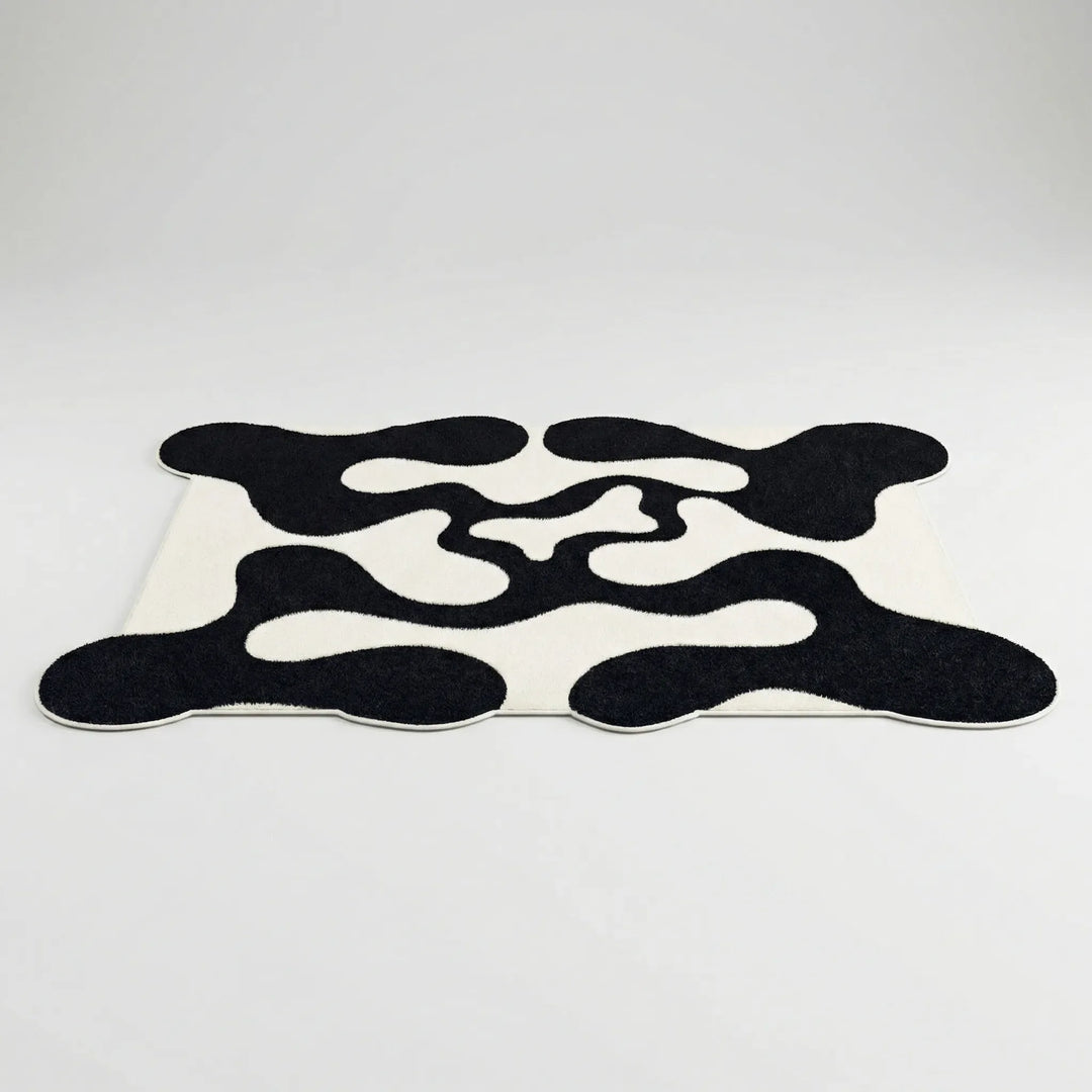 Contemporary statement area rug featuring an abstract wave design. Ideal modern floor decor for any space.