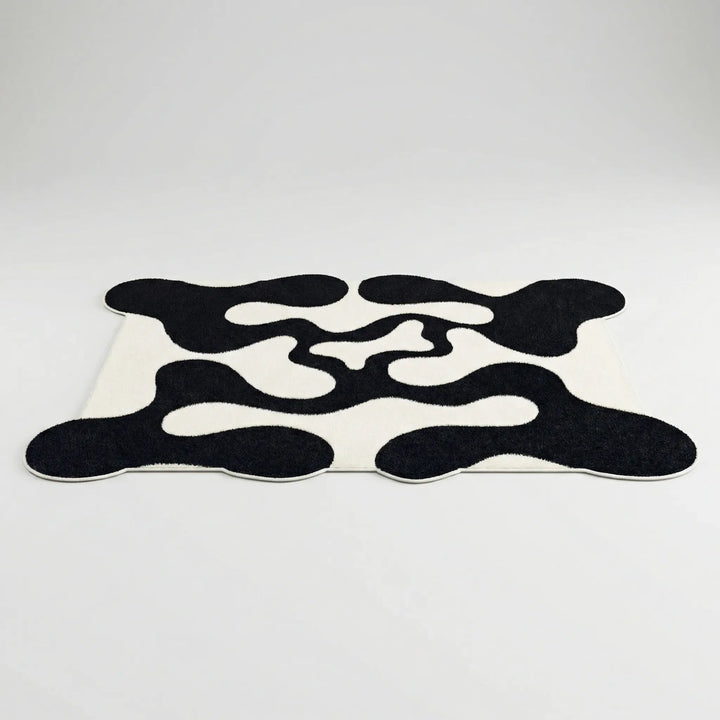 Contemporary statement area rug featuring an abstract wave design. Ideal modern floor decor for any space.