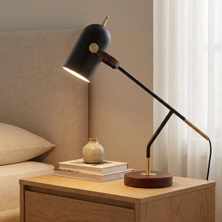 Modern adjustable Deskora desk lamp with a sleek dark finish and gold accents, perfect for office lighting.