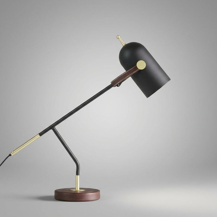 Adjustable arm Deskora table lamp featuring a unique leather base, ideal for home office decor and task lighting.