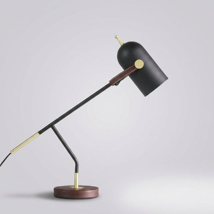 Stylish Deskora table lamp providing optimal task lighting, with a flexible arm and elegant gold detailing.