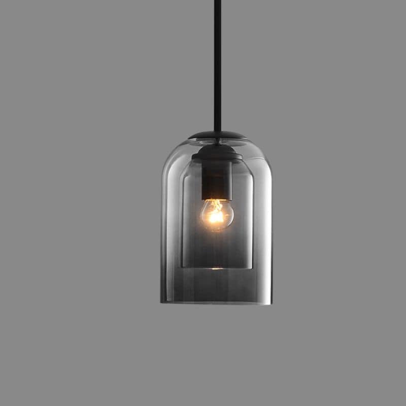 Elegant modern AuraGlas double glass pendant light casting ambient glow in a stylish dining space.