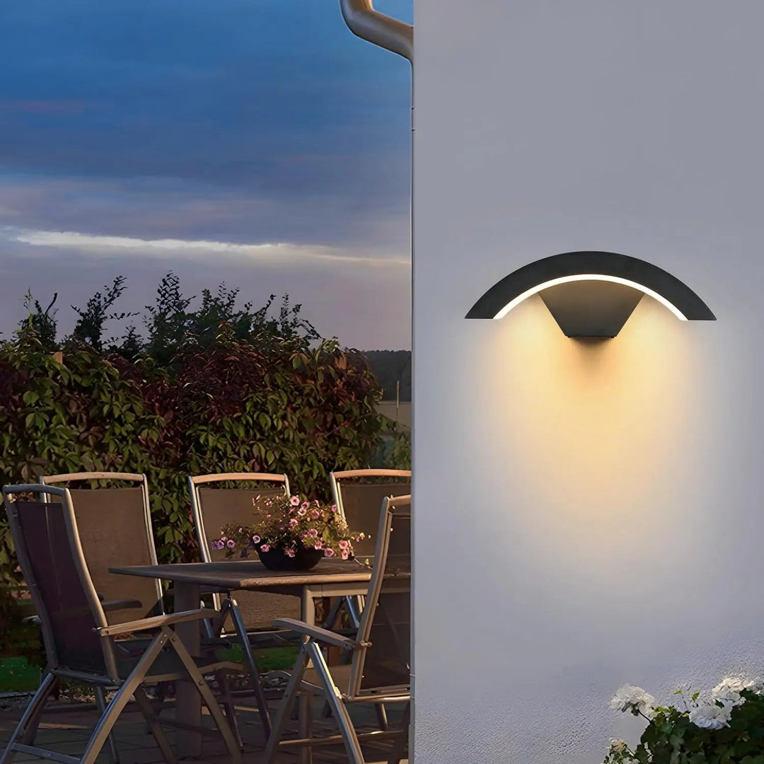 Durable black outdoor wall sconce with integrated LED for stylish and functional patio lighting.
