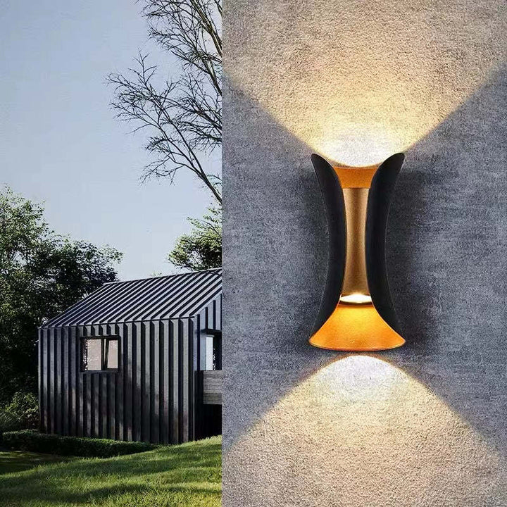 Energy-efficient outdoor LED wall sconce, gold finish, for contemporary homes.
