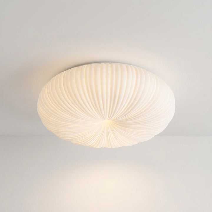 Dimmable LED flush mount ceiling light, providing a soft ambient glow for modern living rooms.