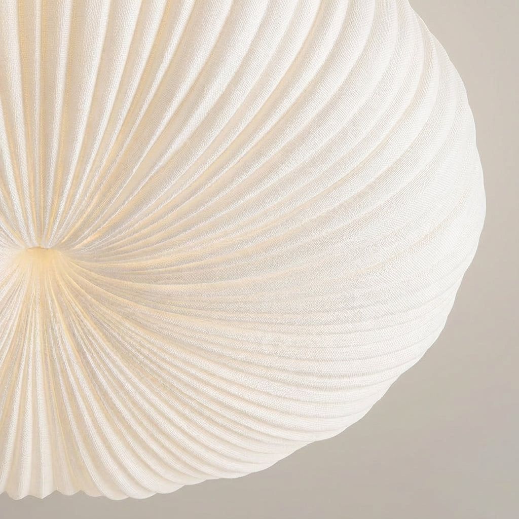 Sleek, sculpted modern flush mount ceiling fixture, offering energy-efficient ambient lighting for contemporary interiors.