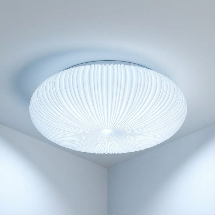 Energy-efficient modern flush mount ceiling light, creating a soft, warm ambient glow in any contemporary space.