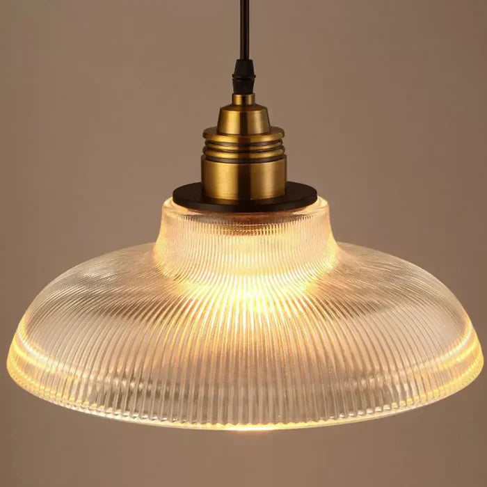Sleek clear glass pendant lighting fixture, a modern ceiling light for any interior space.
