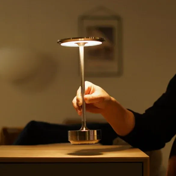 Modern dimmable wireless table lamp, rechargeable & waterproof for indoor/outdoor use.