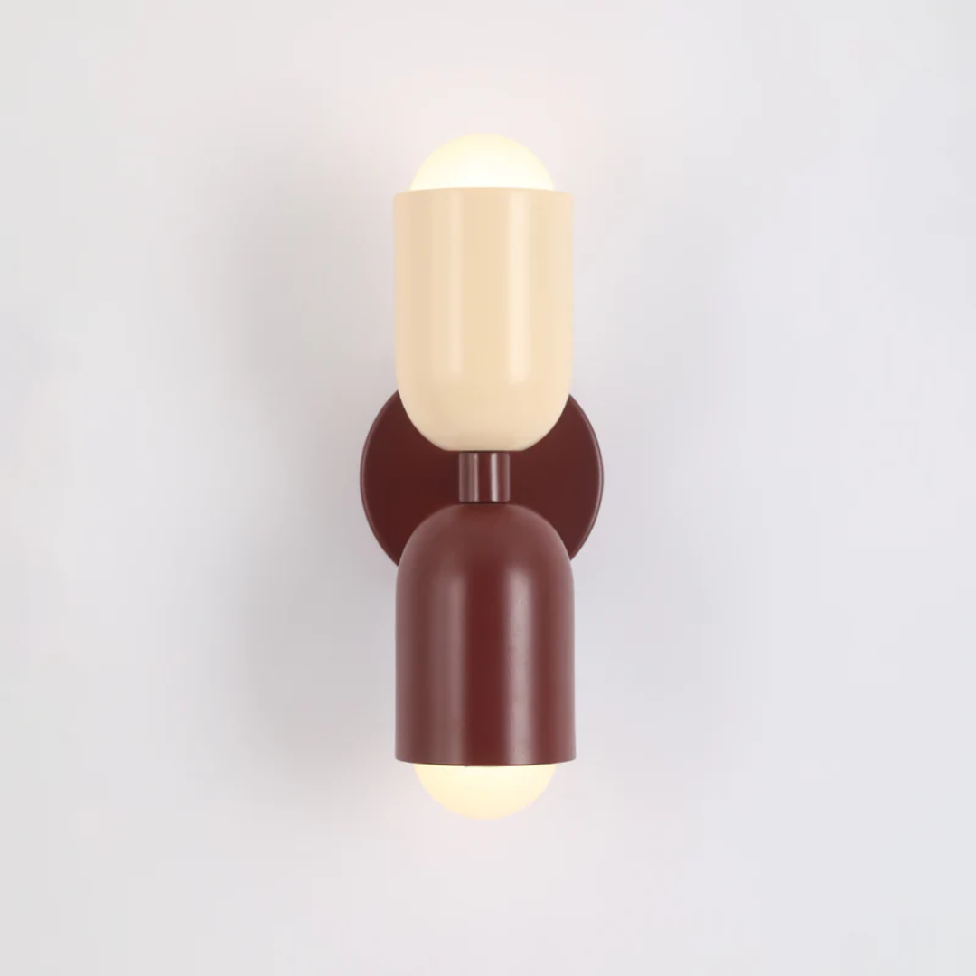 Contemporary metal wall lamp with double-sided LEDs, enhancing modern interior design and vibrant ambiance.