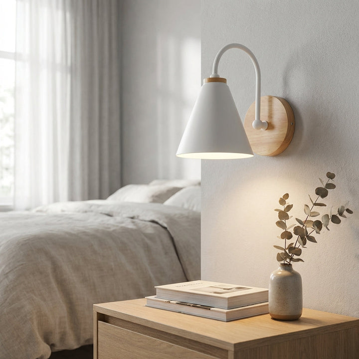 Modern downward cone shade wall sconce in a minimalist living room, adding ambient light and sleek home decor.