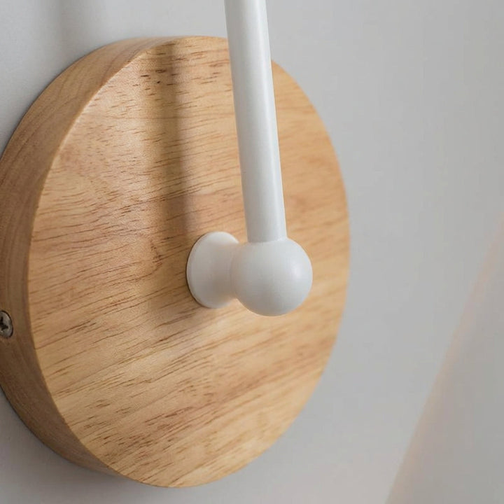 Close-up of a modern cone shade wall sconce, highlighting its sleek design and providing focused ambient lighting.