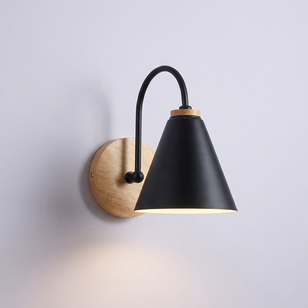 Stylish wall sconce with a downward cone shade providing a soft glow, perfect for modern home decor.