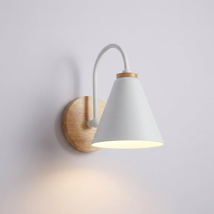 Minimalist AureliaLamp wall sconce with a unique cone shade, enhancing a contemporary interior with its modern lighting.