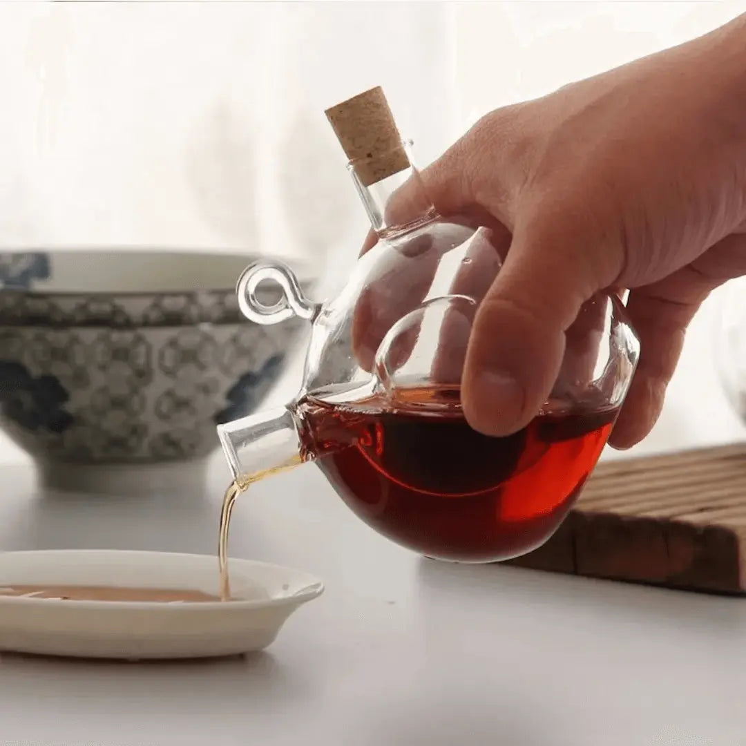 Convenient dual oil & vinegar dispenser with modern glass design. Essential kitchenware for cooking & seasoning.