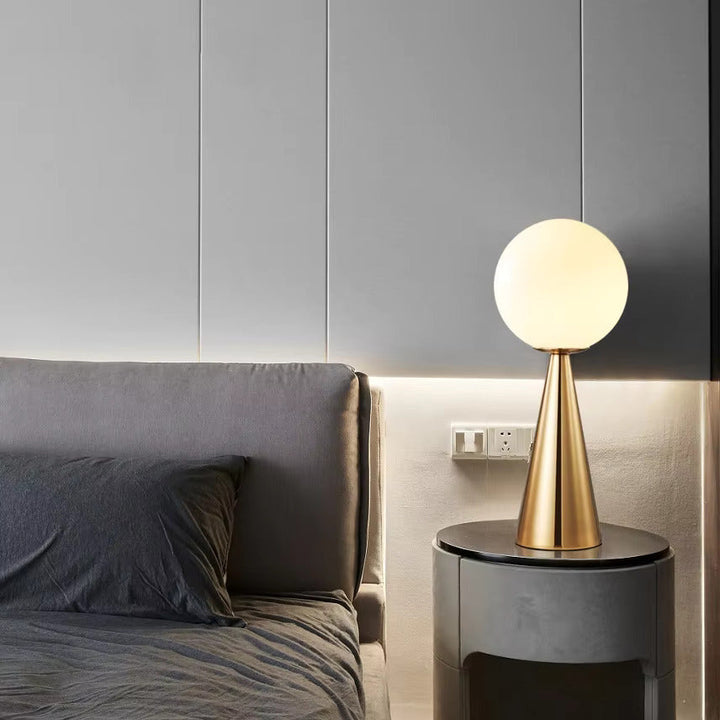 Minimalist gold cone lamp, a sleek desk lamp providing ambient lighting for any modern space