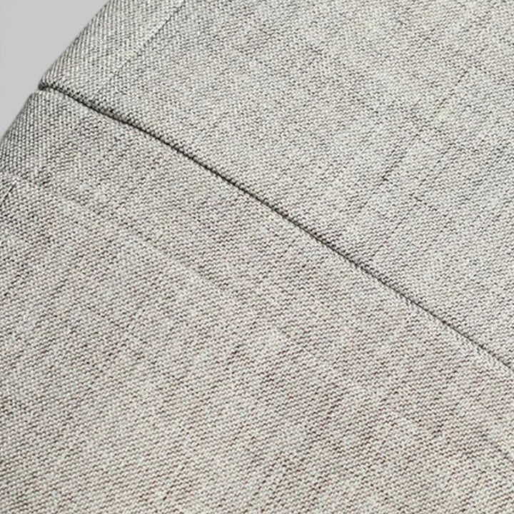 Close-up of lapel and two-button detail on a stylish men's business casual blazer.