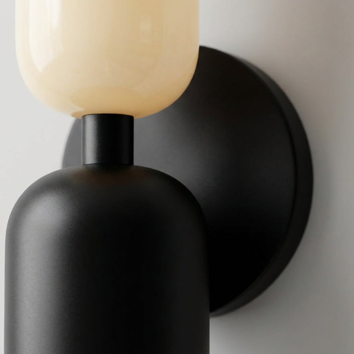 Stylish geometric wall sconce featuring a unique dual-tone shade, decorative modern lighting