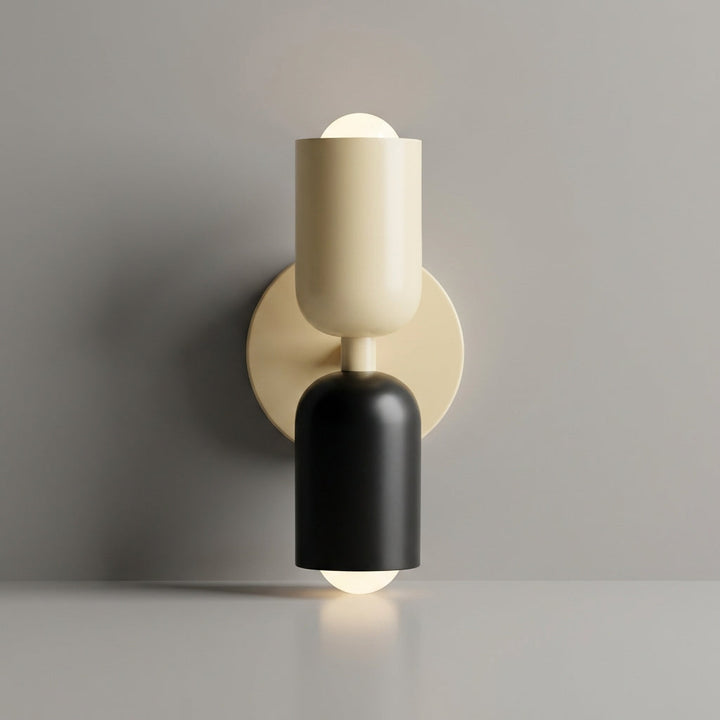 Close-up of geometric wall sconce, highlighting the dual-tone shade's metal and glass details