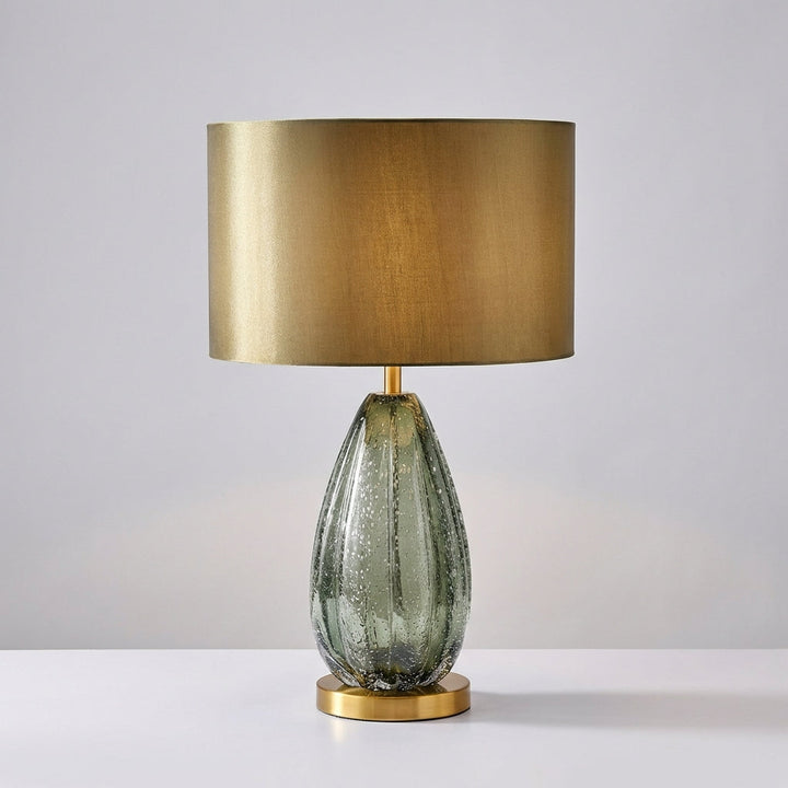 Luminarex green glass table lamp, a modern lighting fixture with a Scandinavian style fabric shade.
