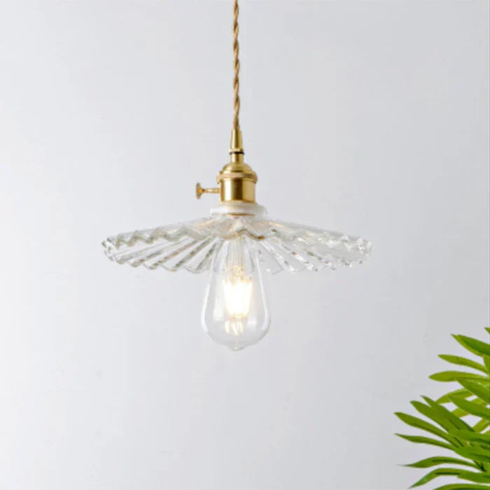 Modern transparent glass pendant lamp, elegant hanging light for dining room decor.