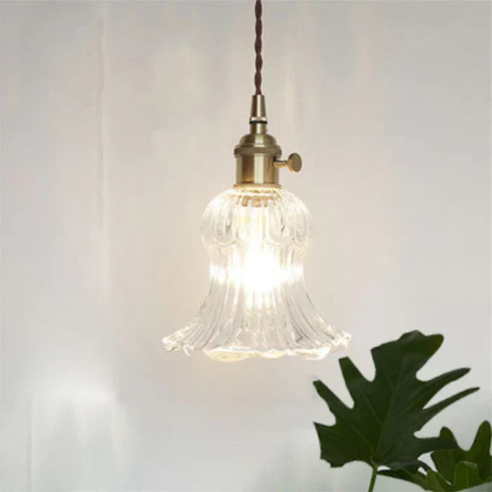Clear glass pendant lamp, providing elegant & modern lighting for dining room ambiance.