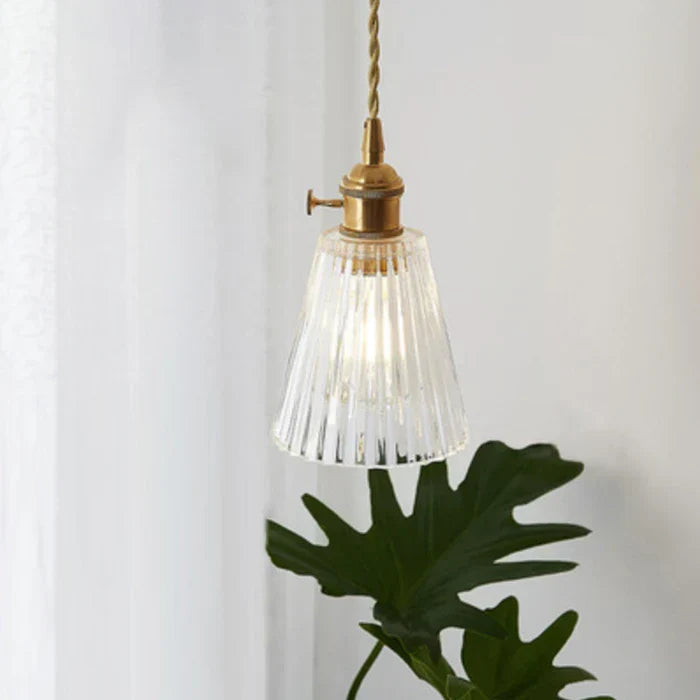Sleek modern glass pendant lamp, transparent hanging light for contemporary dining rooms.