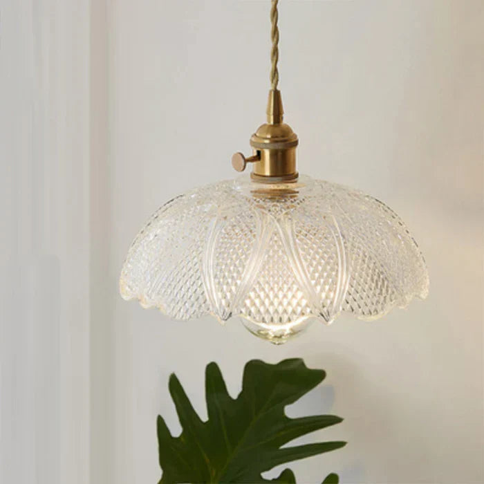 Clear tempered glass pendant lamp, modern hanging light for elegant dining room decor.