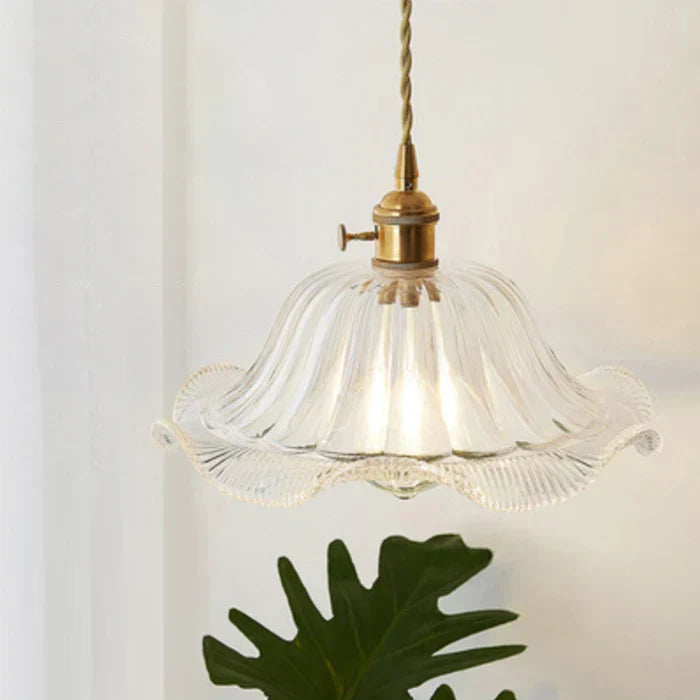 Elegant clear glass pendant lamp, modern industrial lighting for dining or kitchen spaces.