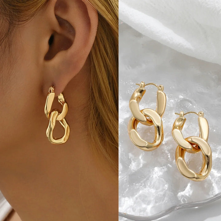 Modern gold interlocking link earrings for women, a chunky fashion statement accessory.