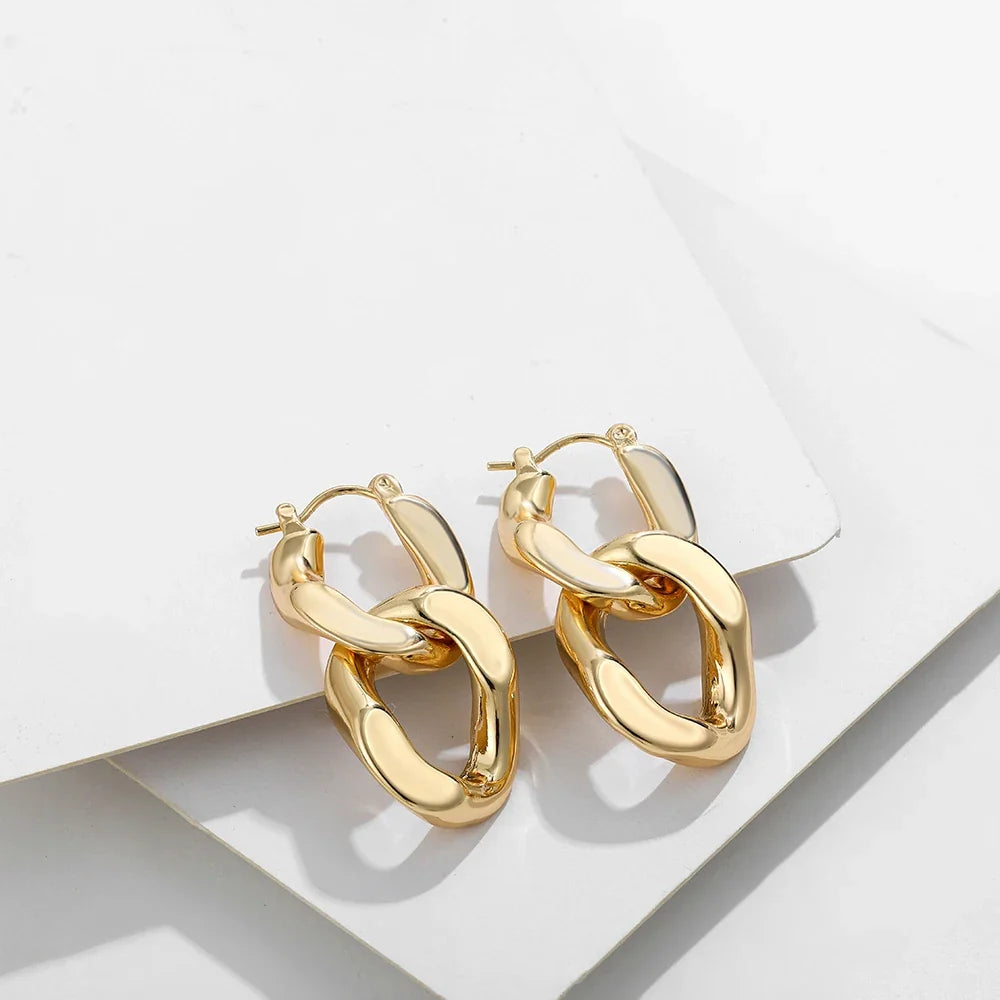 Elegant women's gold interlocking link earrings, a modern chunky gift for her & trendy fashion accessory.