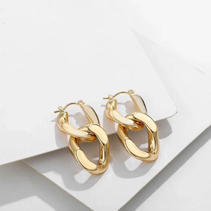 Elegant women's gold interlocking link earrings, a modern chunky gift for her & trendy fashion accessory.