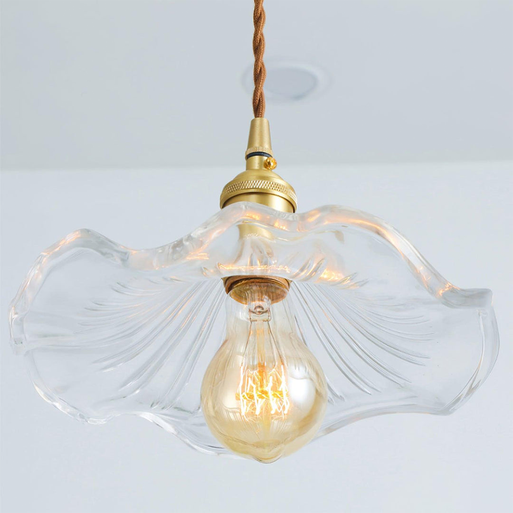 Decorative glass hibiscus flower pendant lamp, a modern ceiling light for ambient home lighting.