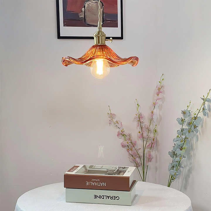 Stylish unisex hibiscus flower light, a modern glass and brass pendant lamp for home.