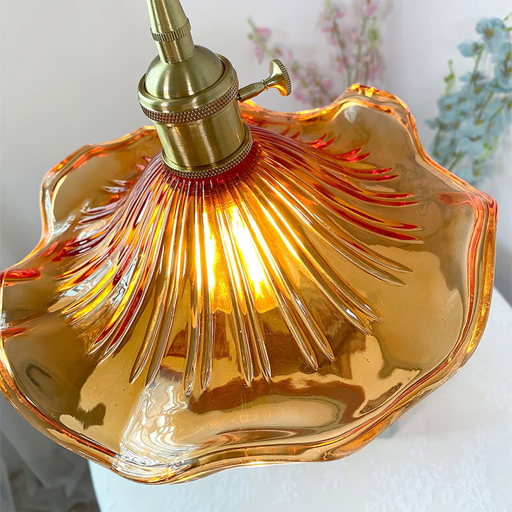 Brass accented hibiscus flower lamp, a modern glass pendant light fixture for home decor.