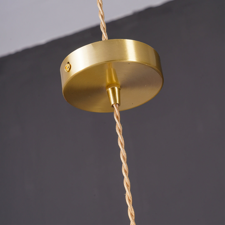 Sophisticated hibiscus flower pendant lamp, a glass and brass lighting fixture for modern homes.